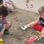 Children playing in the sand at inclusive playground